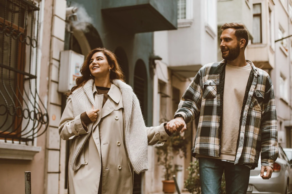 A couple reunited, talking and holding hands — illustrative photograph