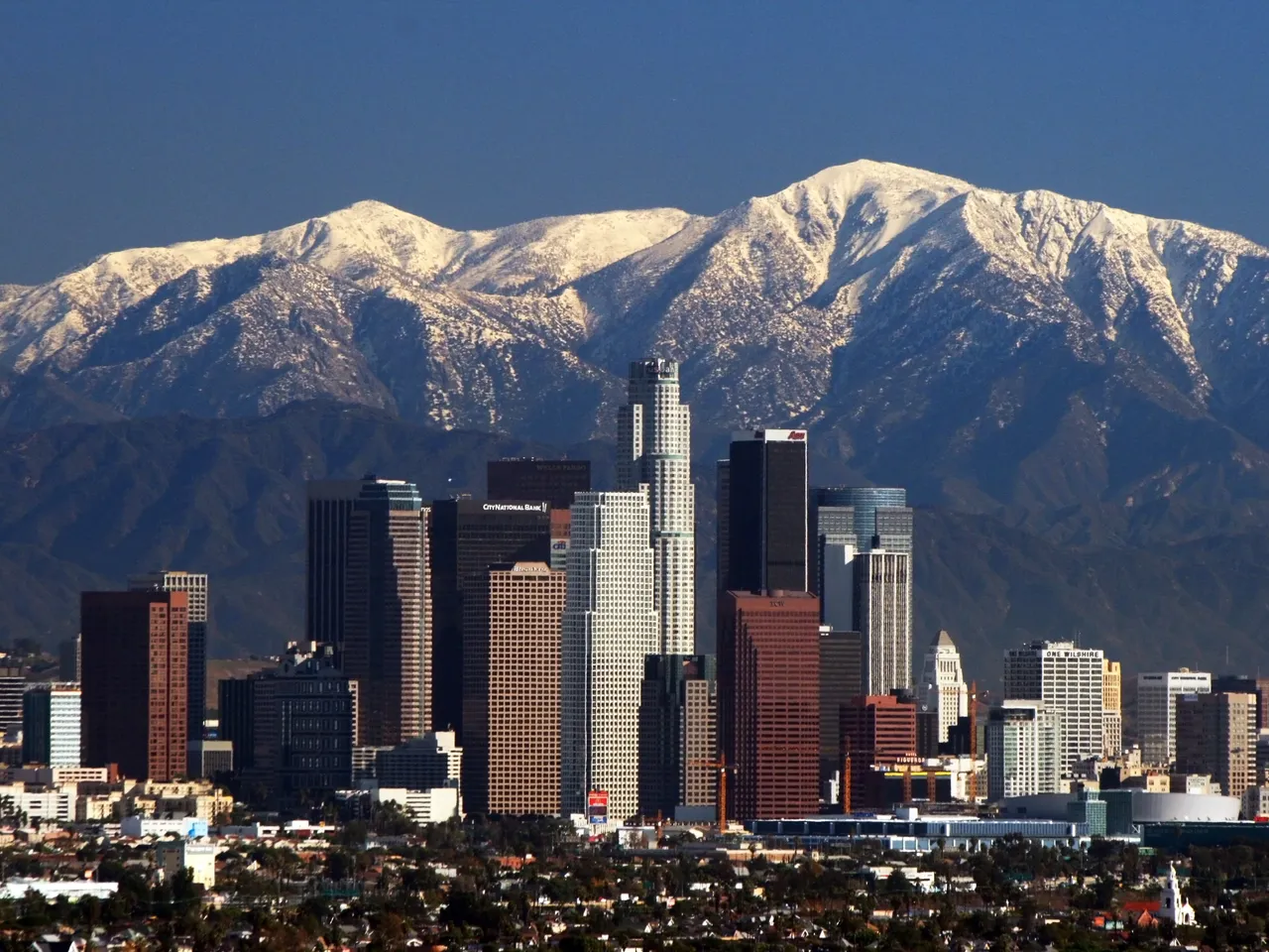 Downtown Los Angeles skyscrapers in front of the snow-capped San Gabriel Mountains