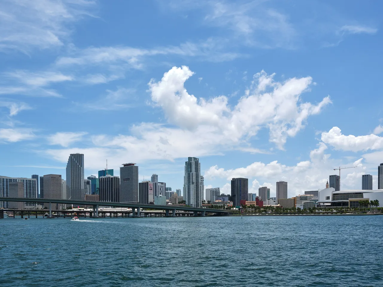 Downtown Miami’s towers seen from Biscayne Bay, with a long bridge crossing the water on the left